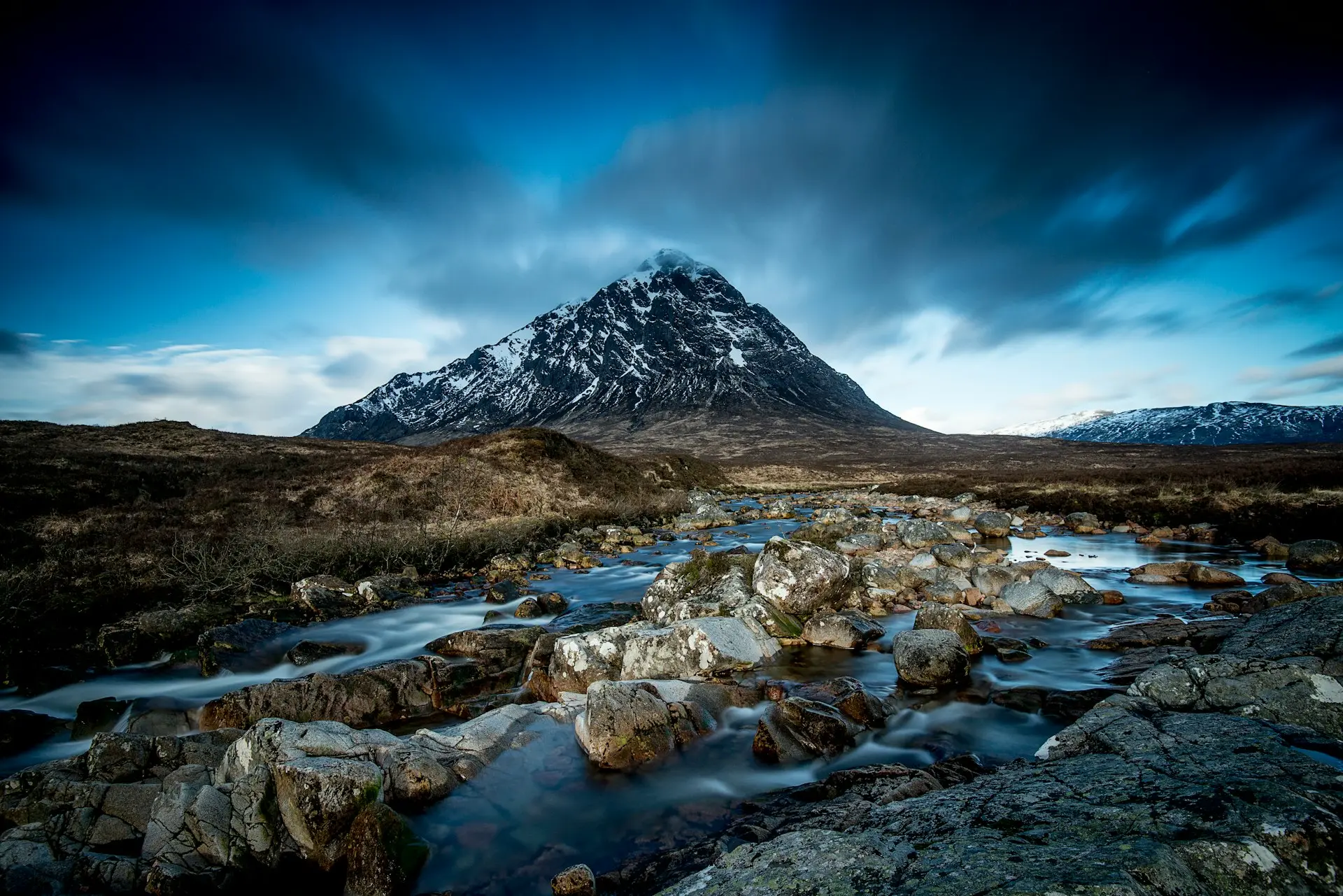 body of water at the foot of mountain